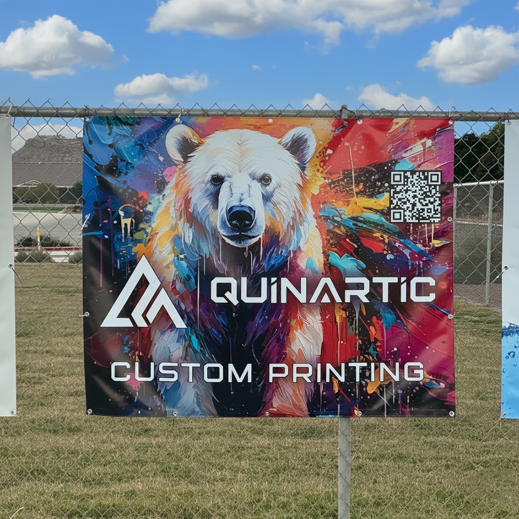 Image of a colorful bear graphic with Quinartic Custom Printing logo on a 18 oz banner hanging on a school fence.